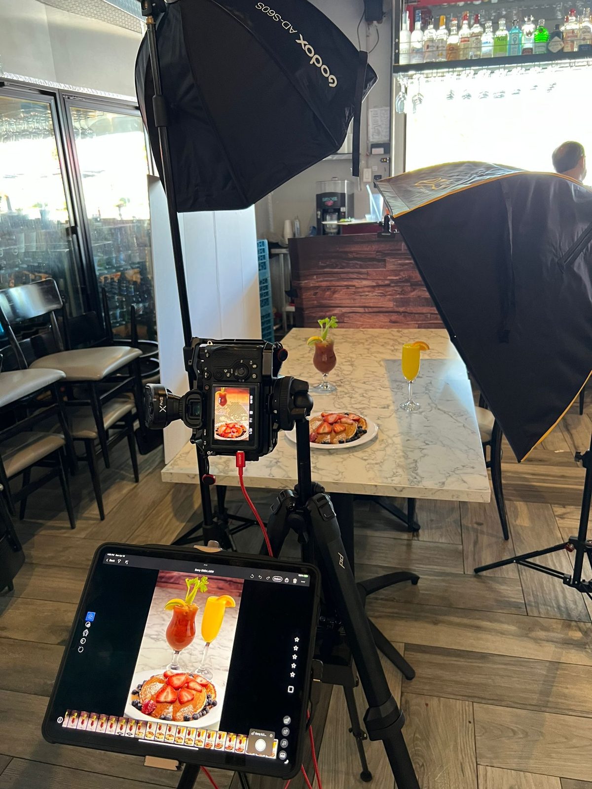 Tethered tablet showing a cocktail photo beside the set
