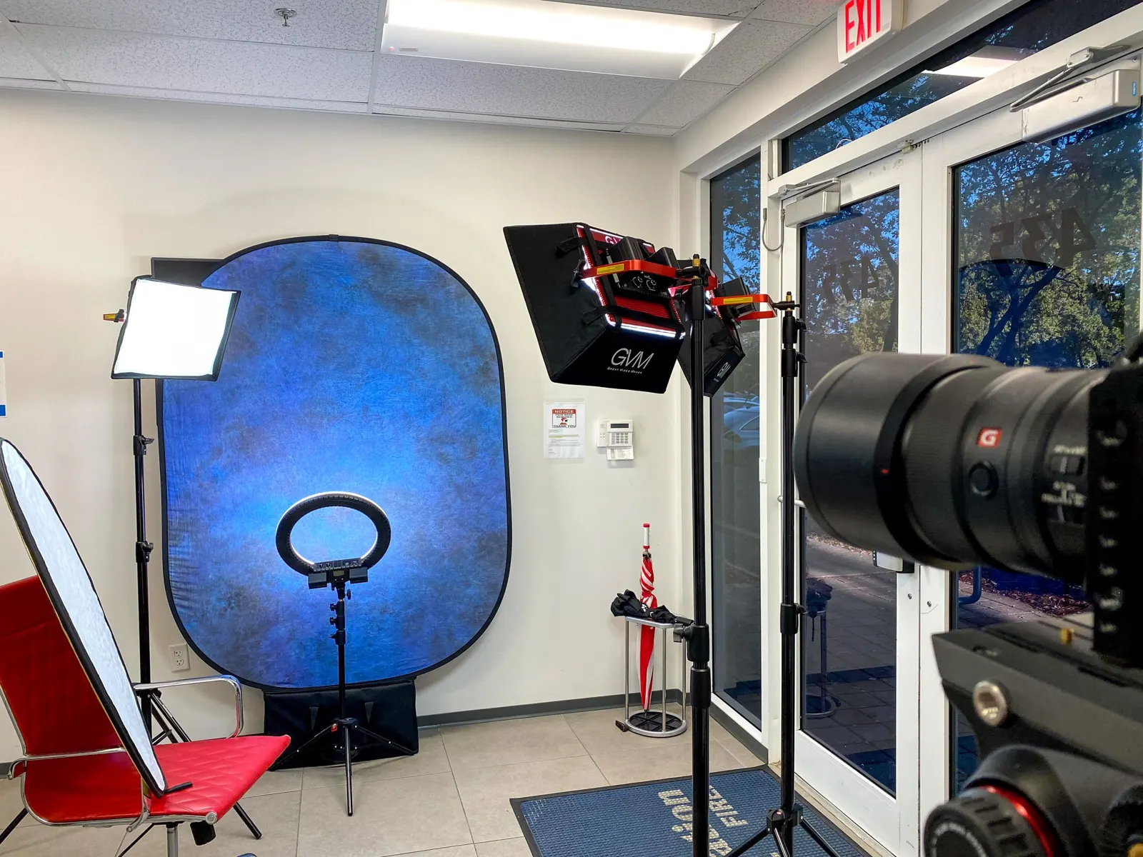 A backdrop, ring light and cinema lens ready for headshots in an office lobby