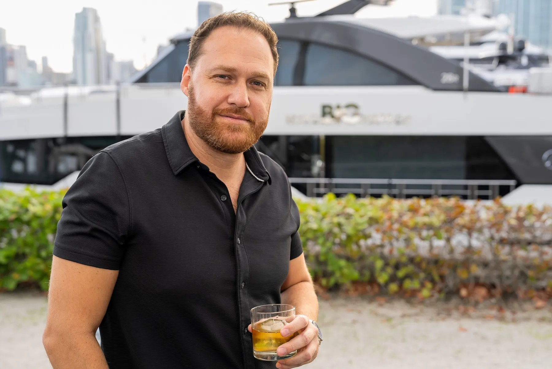 A guest on the dock in front of a yacht in Miami