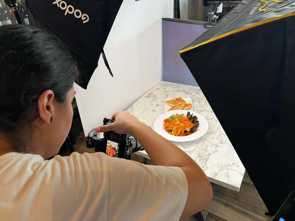 Our photographer shooting a plated dish between two softboxes