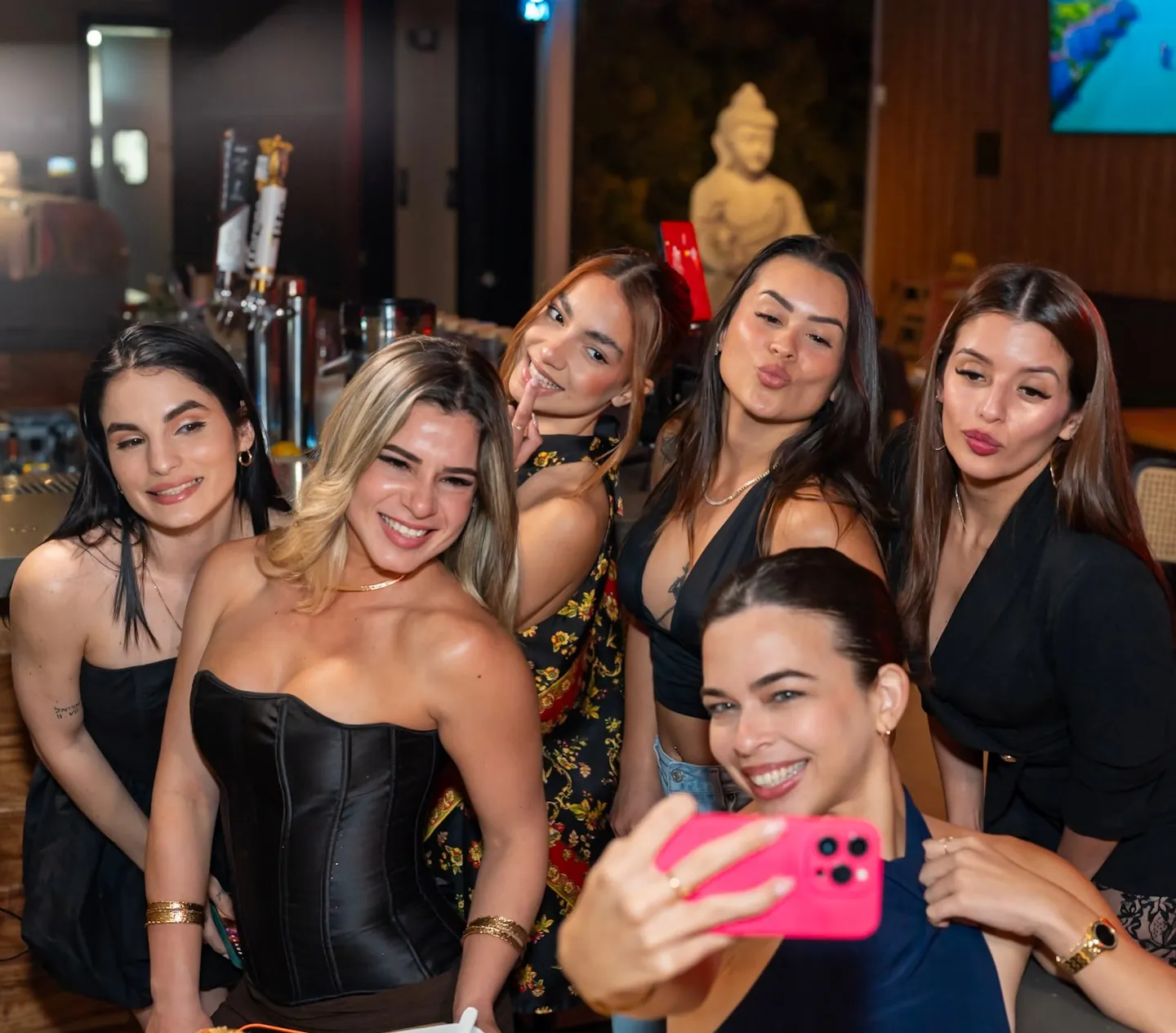 Friends taking a selfie at a client event we shot for social