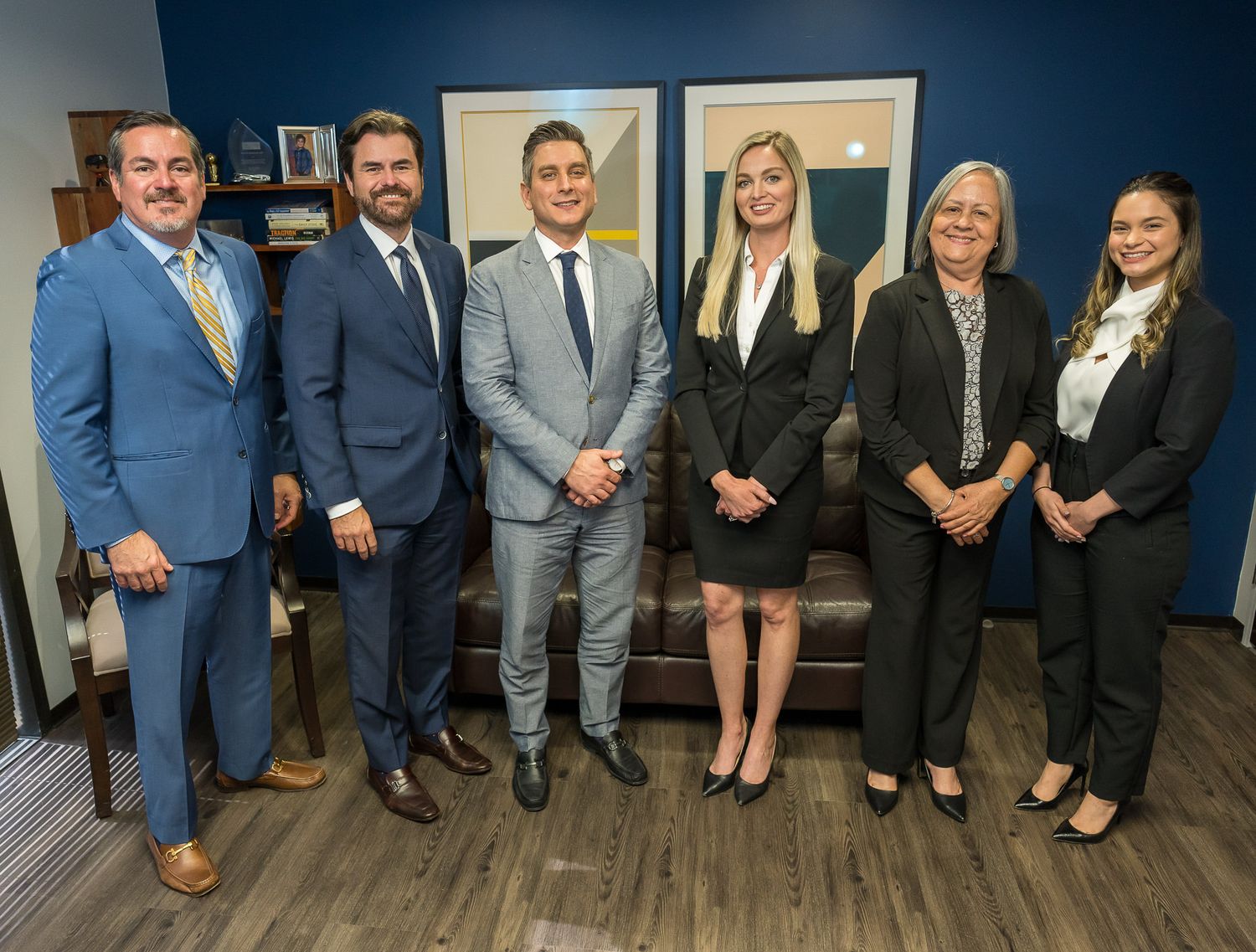 Full staff team portrait in a high-rise office lobby