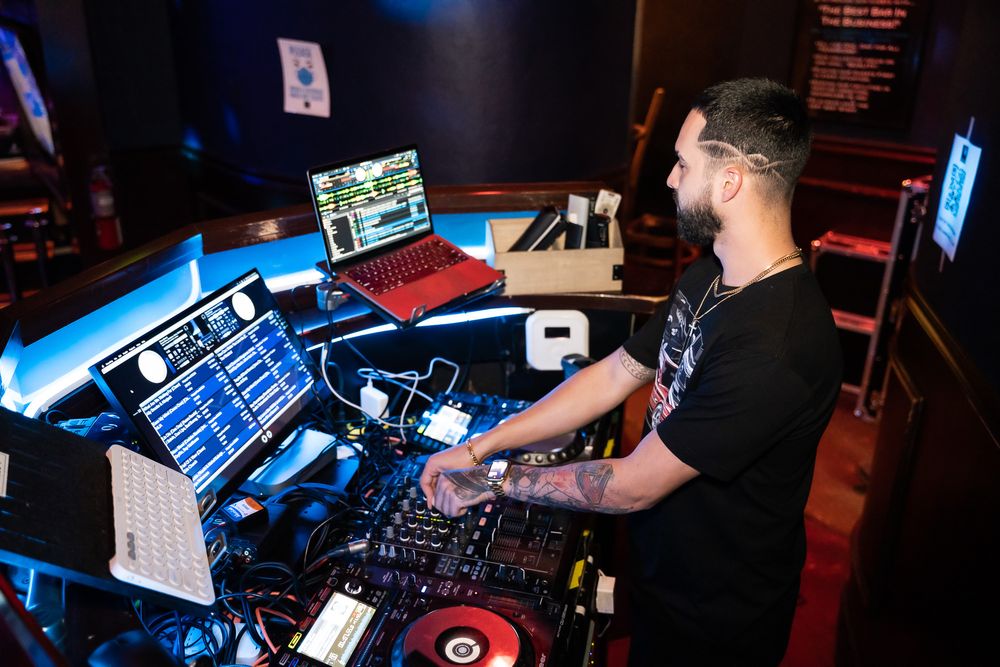 DJ performing behind the turntables at a night event