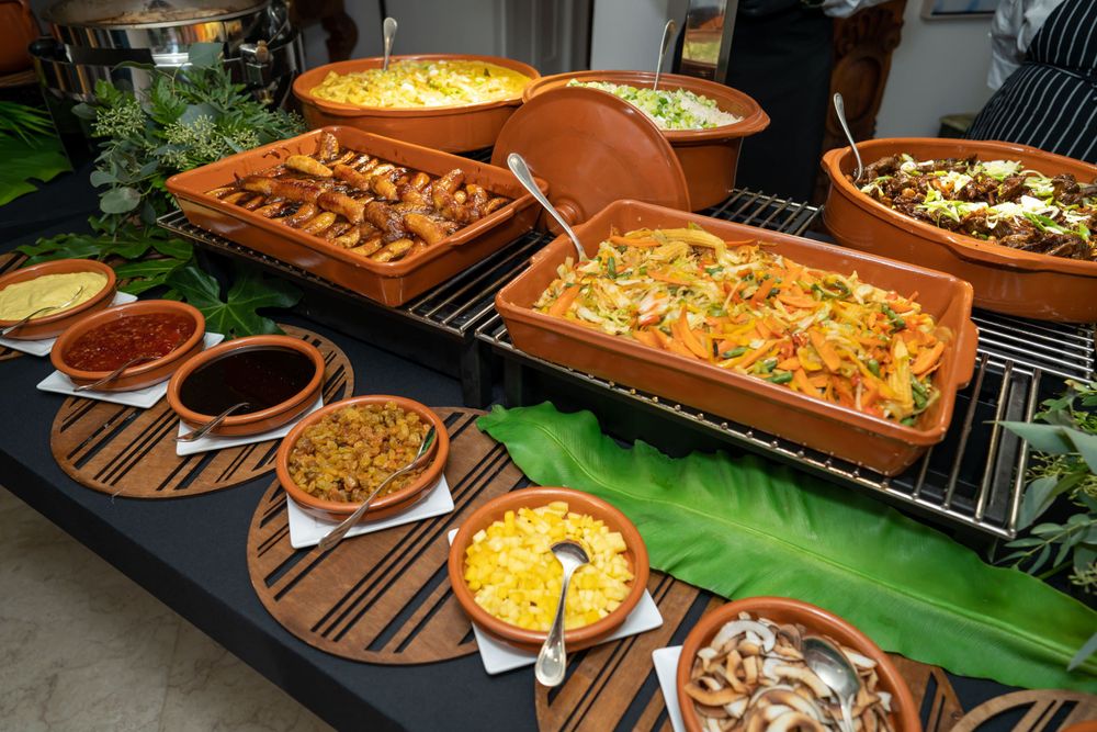 Catering spread of dishes displayed on a banana leaf lined table