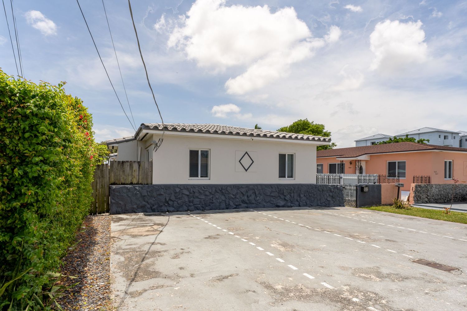 Single-family home exterior with a paved driveway and mature landscaping