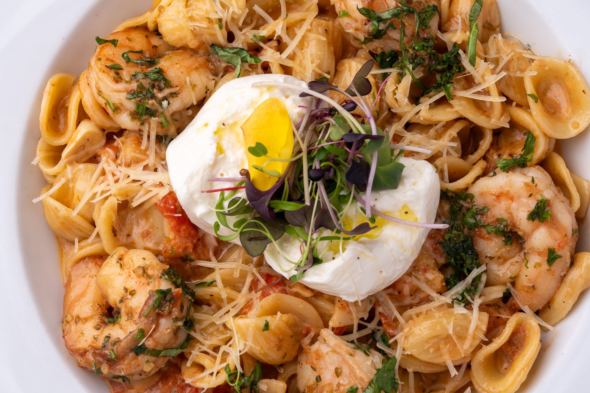 Shrimp pasta topped with a poached egg
