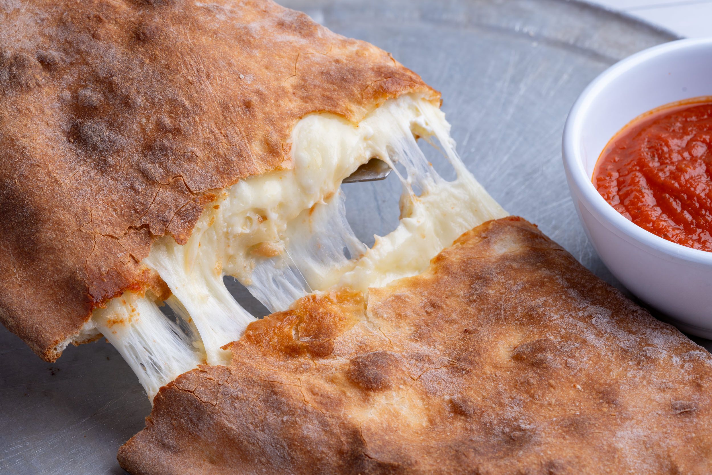 Cheese pull from a slice of pizza