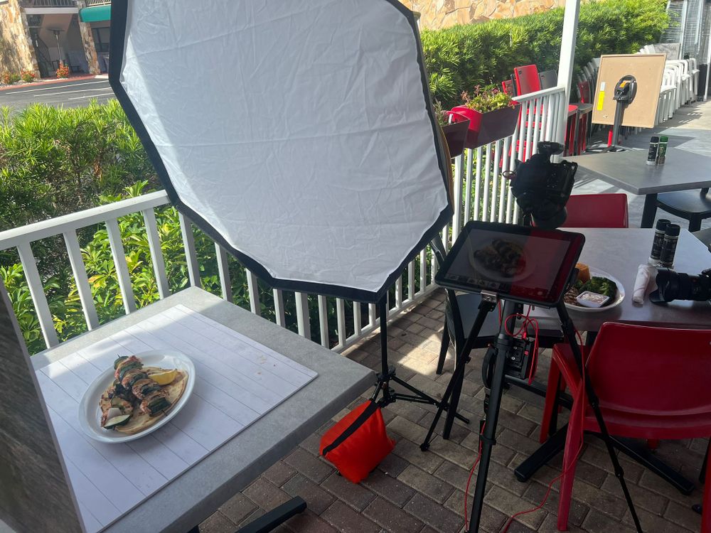 Una softbox iluminando un plato servido en una mesa de terraza